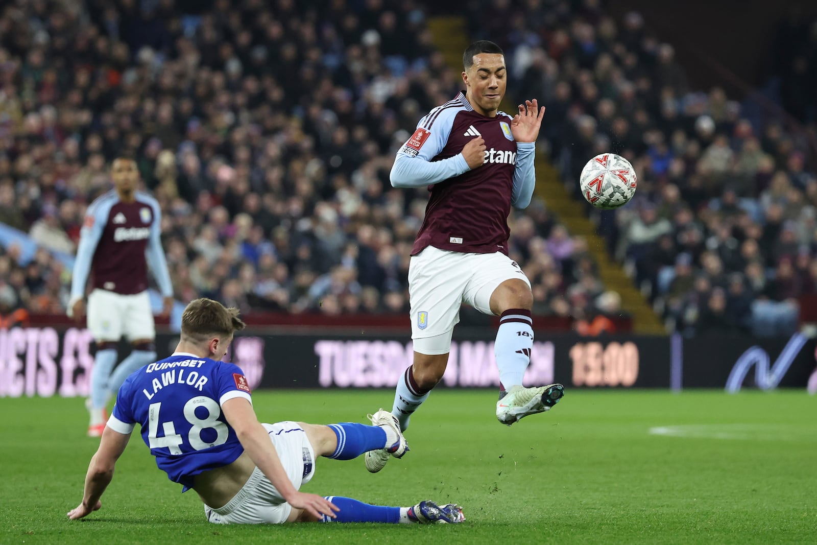 Aston Villa's Youri Tielemans, right, and Cardiff City's Dylan Lawlor challenges for the ball during the English FA Cup fifth round soccer match between Aston Villa and Cardiff City at the Villa Park stadium in Birmingham, England, Friday, Feb. 28, 2025. (AP Photo/Darren Staples)