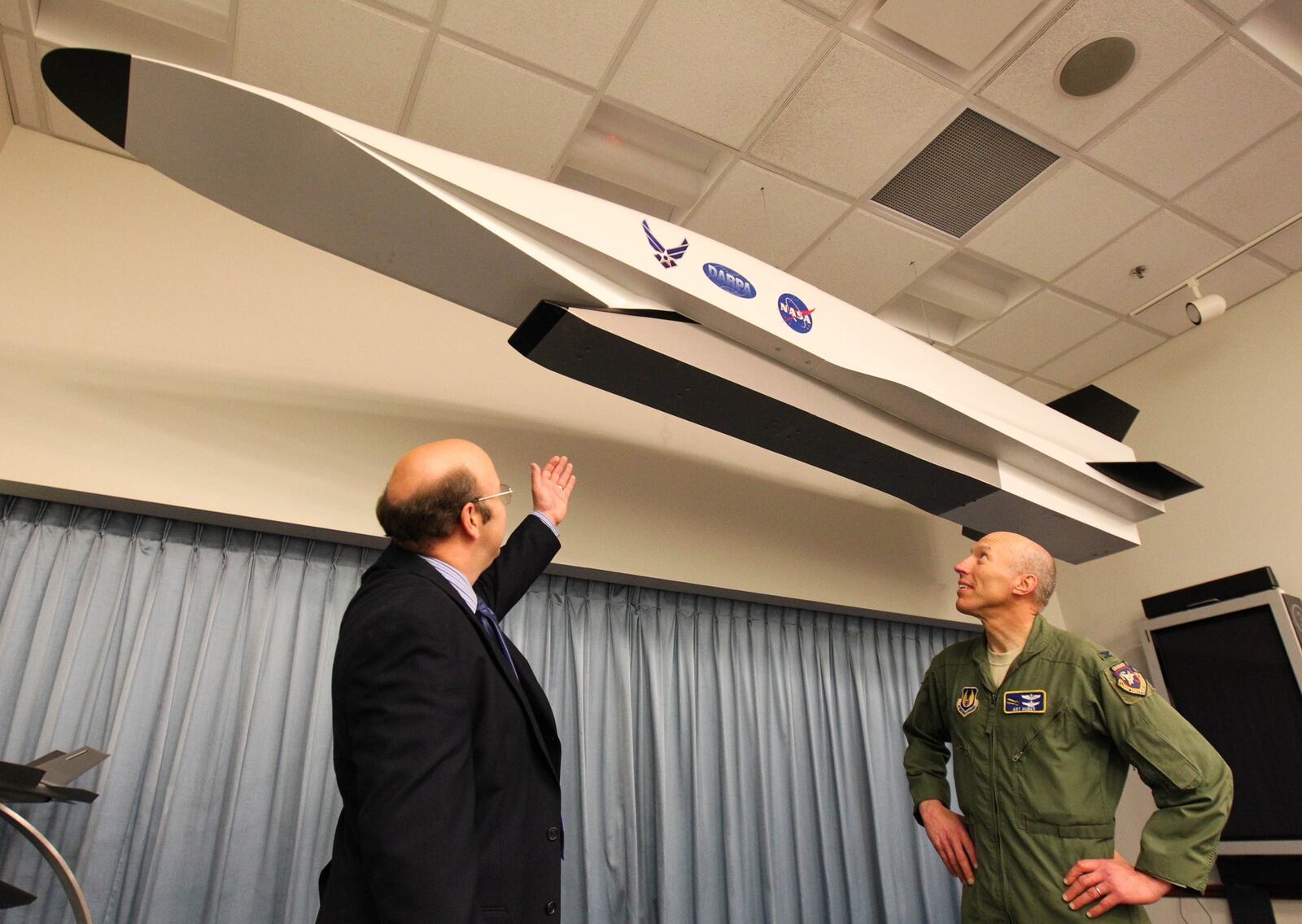 Left, Glenn Liston, Aerospace Engineer and Col. Art Huber with a 1500 lb. 14 foot full scale mockup of the X-51 Hydrodcarbon Scramjet Powered Hypersonic Waverider Flight Demonstration Vehicle, a fast flying missle to “take out” distant, time critical targets in minutes. FILE PHOTO