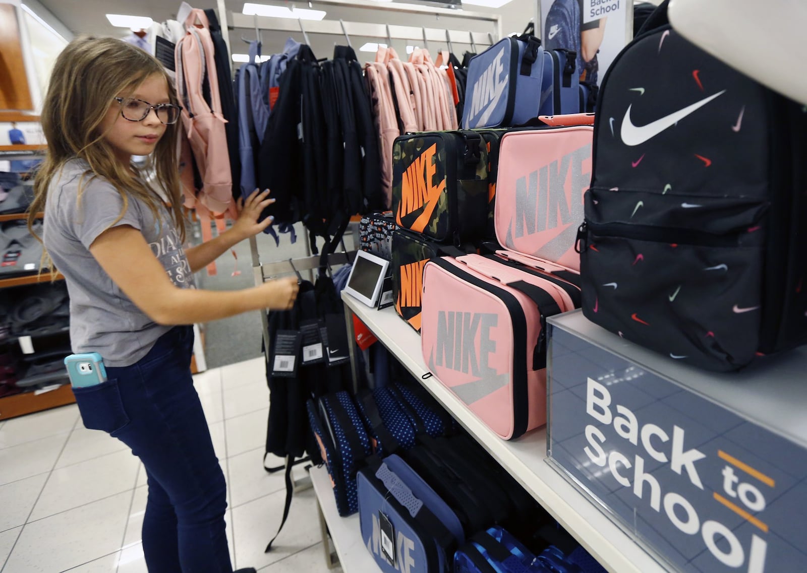 Sophie Henkels, 11, checks out new lunch boxes and backpacks at the Centerville Kohl’s store on Friday. Ohio’s back to school tax free week begins on August 2 this year. TY GREENLEES / STAFF