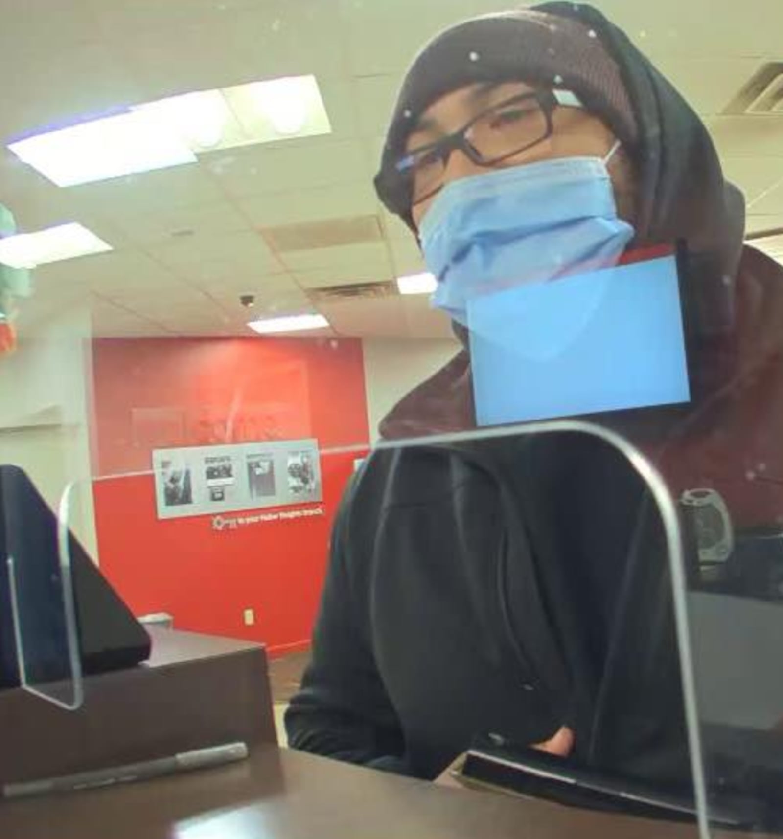 A bank robber brandishes a pistol Wednesday, Feb. 22, 2023, when he holds up the KeyBank branch on Chambersburg Road in Huber Heights. CONTRIBUTED