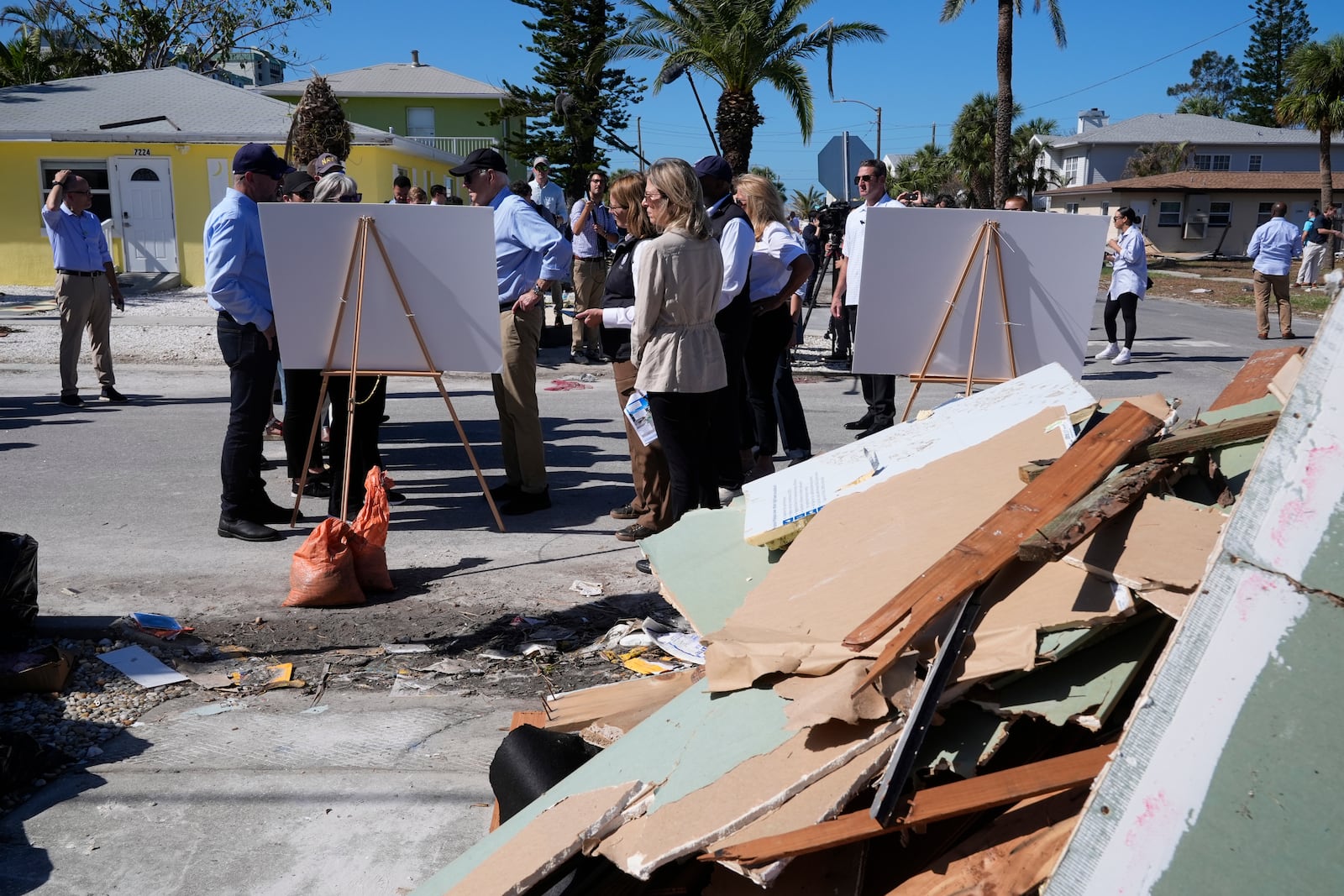 President Joe Biden, second left, is briefed by federal, state, and local officials in St. Pete Beach, Fla., following an aerial tour of the Hurricane Milton affected areas, Sunday, Oct. 13, 2024. (AP Photo/Manuel Balce Ceneta)