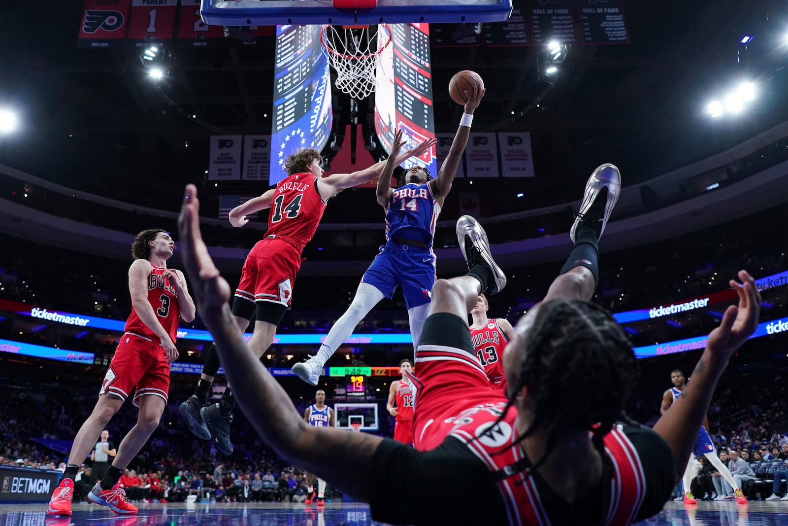 Philadelphia 76ers' Ricky Council IV, right, goes up for a shot against Chicago Bulls' Matas Buzelis during the second half of an NBA basketball game Monday, Feb. 24, 2025, in Philadelphia. (AP Photo/Matt Slocum)