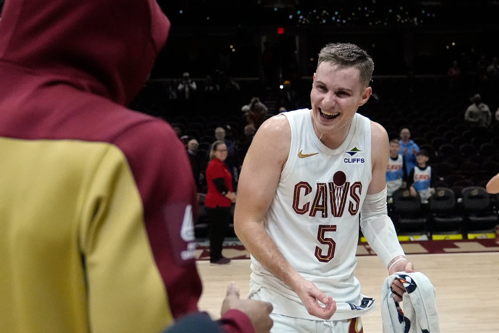 Cleveland Cavaliers guard Sam Merrill (5) reacts after being doused with water by teammate Donovan Mitchell, left, during a an on-court interview after an NBA basketball game against the Dallas Mavericks, Sunday, Feb. 2, 2025, in Cleveland. (AP Photo/Sue Ogrocki)