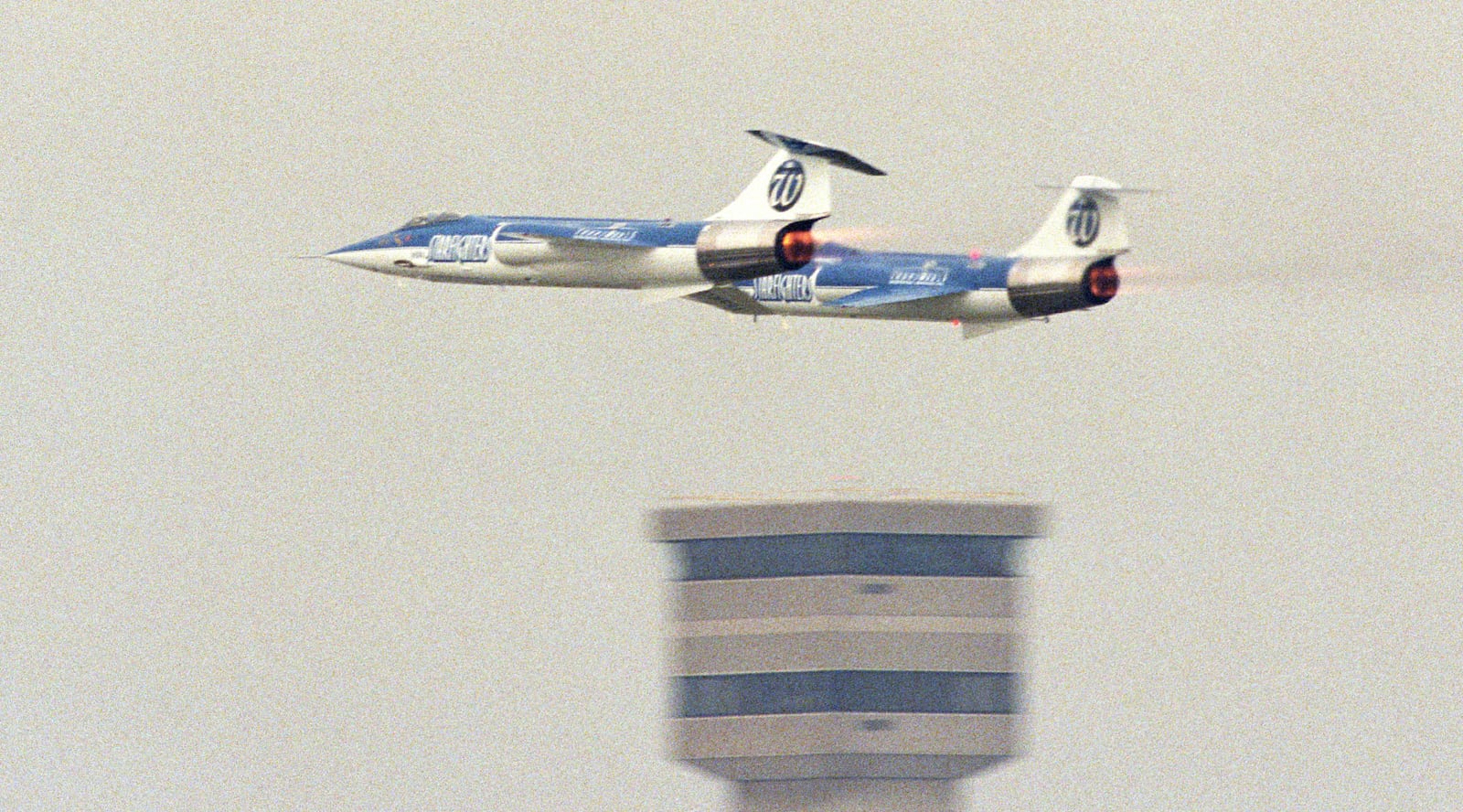 F-104 Starfighters Demo Team screams past the old Emery control tower with full afterburners lit.