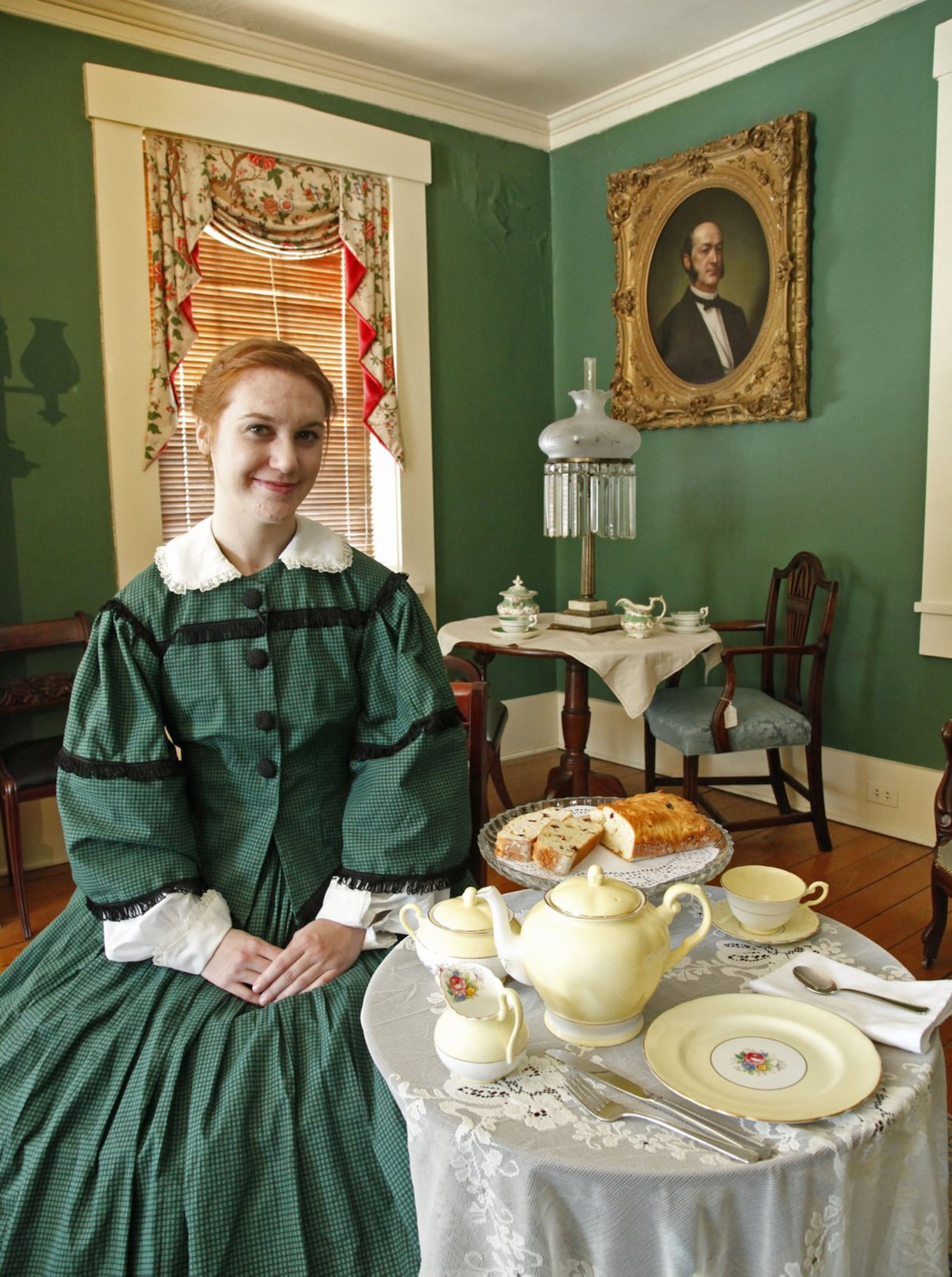 Katie Nowak from Dayton History hosts tea at the Patterson Homestead with period clothing and antique china. TY GREENLEES / STAFF