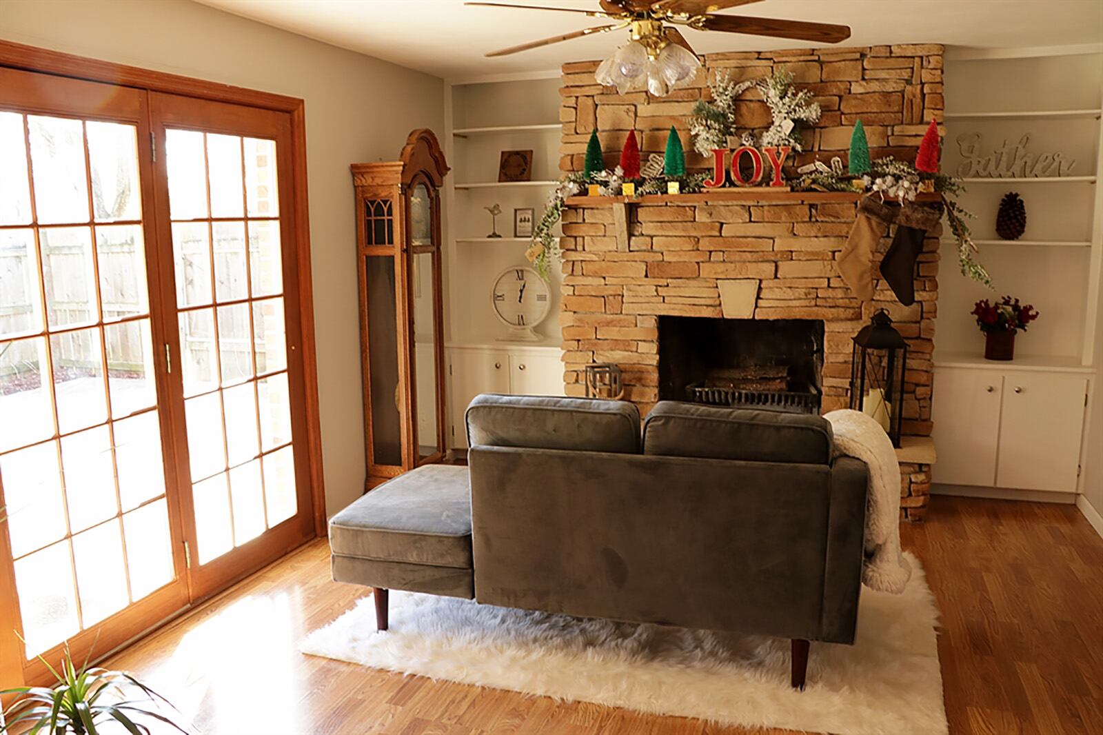 A stacked-stone, wood-burning fireplace with raised stone hearth and wood-beam mantel is the focal point to the family room and can be enjoyed from the dining room. Built-in bookcases with cabinets beneath flank the fireplace. CONTRIBUTED PHOTO BY KATHY TYLER