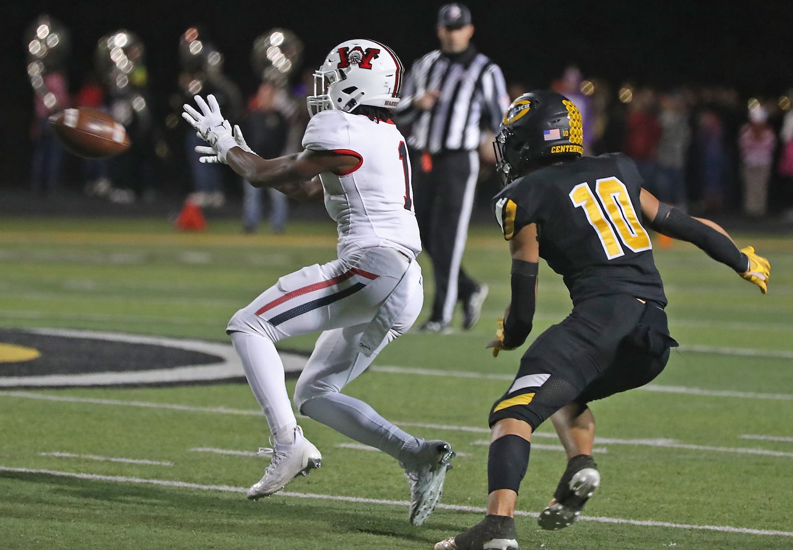 Wayne's RJ Mukes catcbes a pass under pressure from Centerville's Seth Alejandrino during Friday's game. BILL LACKEY/STAFF