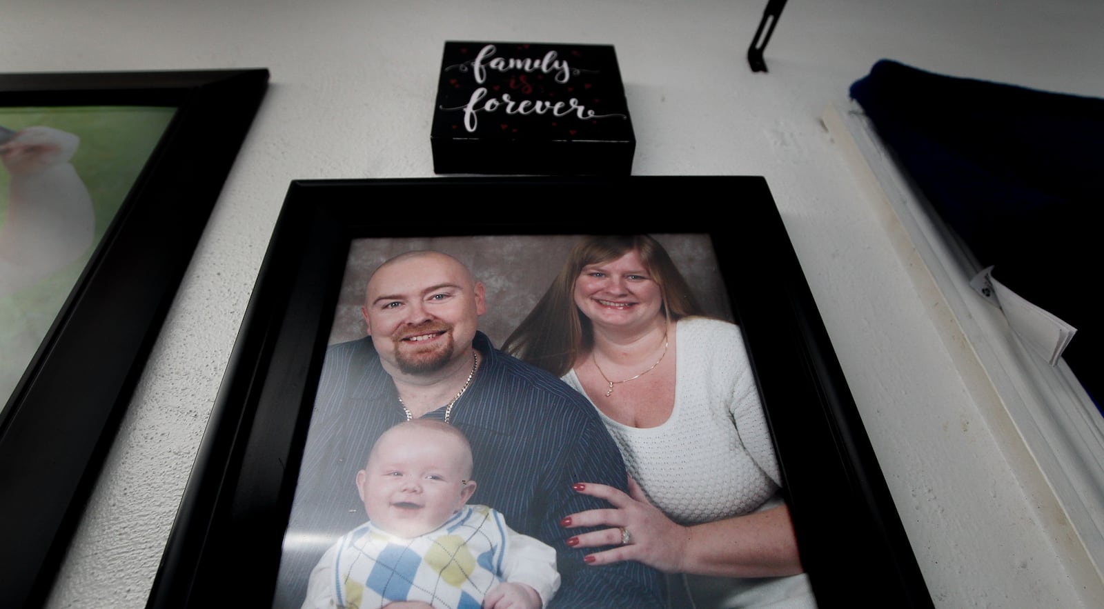 Jessica Brady and her late husband, Jimmy, are seen with their son Jagger. Following Jimmy's death three years ago, Brady stopped paying homeowners insurance to help make ends meet. Then the home where she still lives with Jagger was hit by a Memorial Day tornado. Volunteers from Shiloh Church through Rebuilding Together Dayton worked Thursday, Sept. 19, 2019, to help repair the home in Harrison Twp. CHRIS STEWART / STAFF