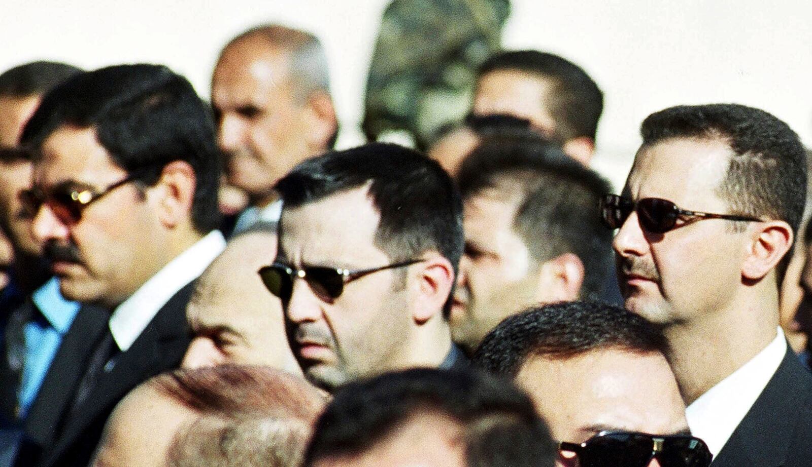 FILE - Bashar Assad, right, and his brother Maher Assad, center, stand during the funeral of their father, former President Hafez Assad, in Damascus, Syria, June 13, 2000. (AP Photo, File)