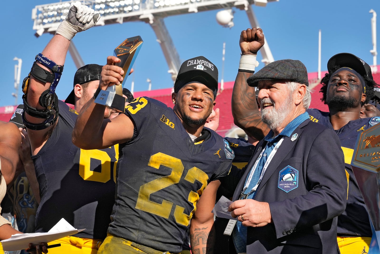 Michigan running back Jordan Marshall (23) celebrates after being named the Most Valuable Player after defeating Alabama during the ReliaQuest Bowl NCAA college football game Tuesday, Dec. 31, 2024, in Tampa, Fla. (AP Photo/Chris O'Meara)