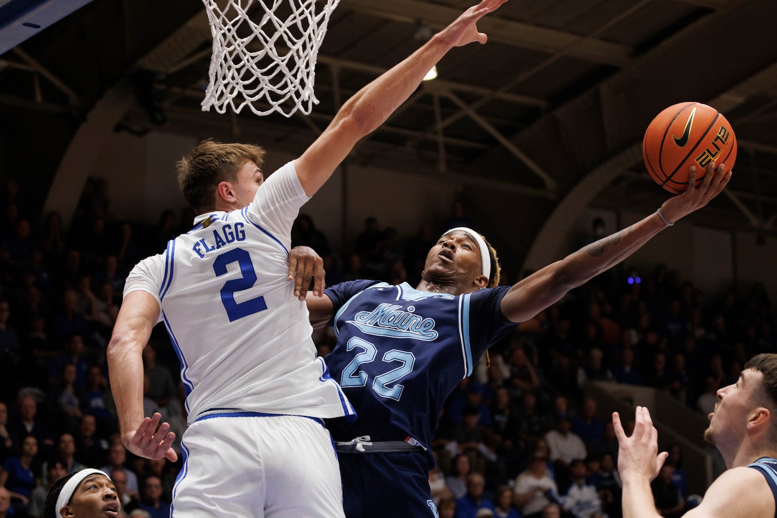 Maine's Quion Burns (22) attempts a shot as Duke's Cooper Flagg (2) defends during the first half of an NCAA college basketball game in Durham, N.C., Monday, Nov. 4, 2024. (AP Photo/Ben McKeown)