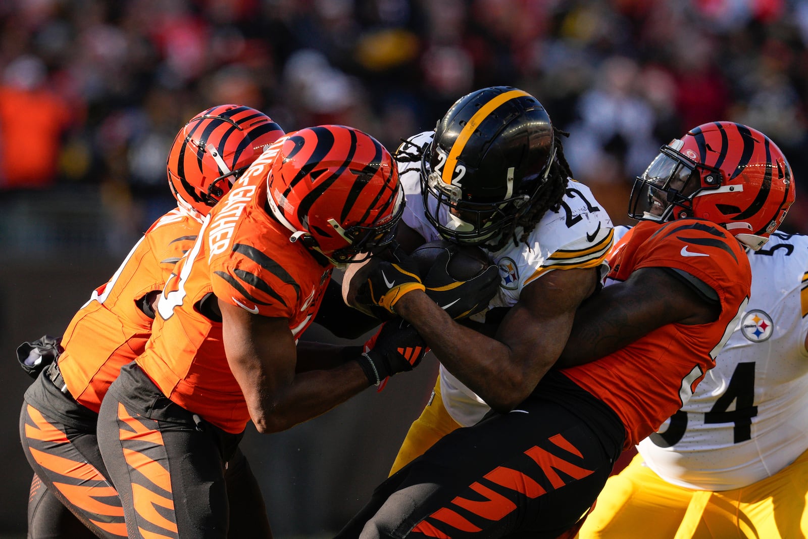 Pittsburgh Steelers running back Najee Harris (22) is tackled by Cincinnati Bengals linebacker Akeem Davis-Gaither, front left, during the first half of an NFL football game Sunday, Dec. 1, 2024, in Cincinnati. (AP Photo/Jeff Dean)