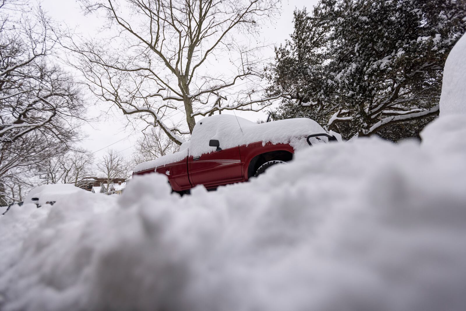 Snow accumulates on a truck in Norfolk, Va on Thursday, Feb. 20, 2025. (Billy Schuerman /The Virginian-Pilot via AP)