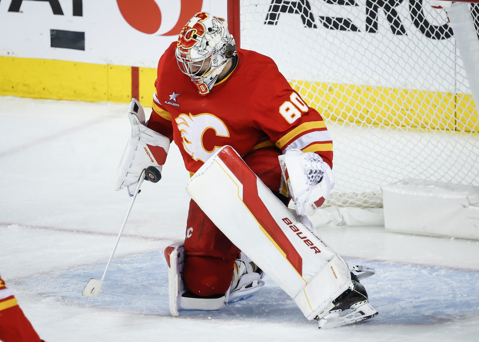 Calgary Flames goalie Dan Vladar deflects a shot during third period NHL hockey action against the Columbus Blue Jackets in Calgary on Tuesday, Dec. 3, 2024. (Jeff McIntosh/The Canadian Press via AP)