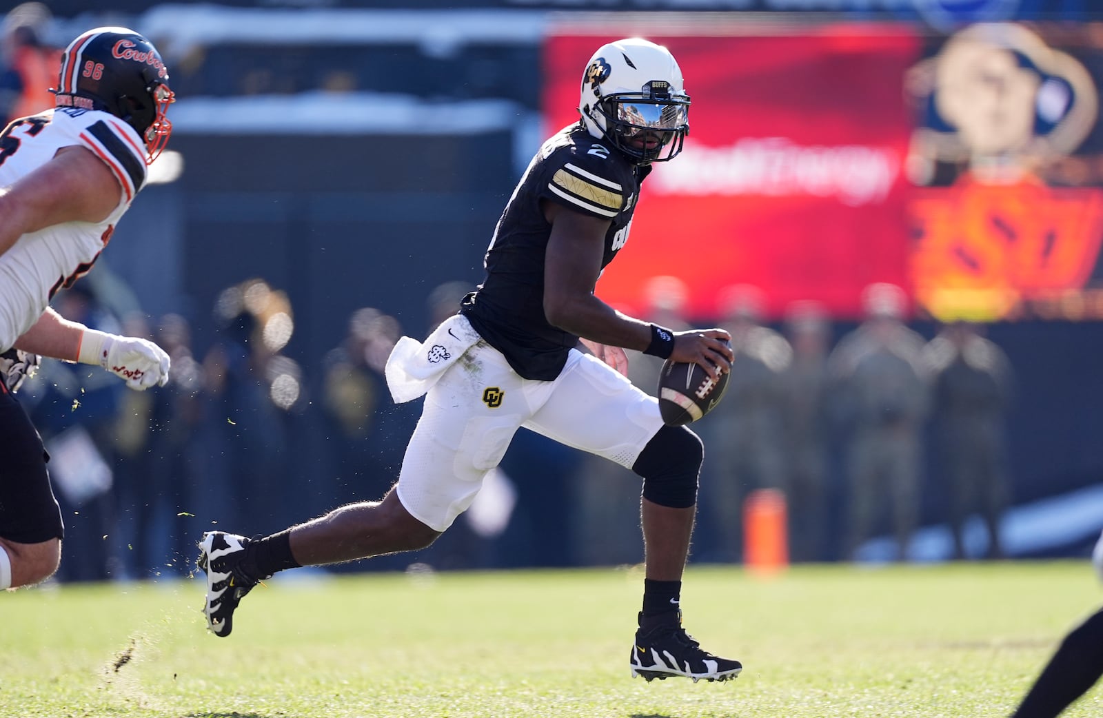 Colorado quarterback Shedeur Sanders avoids Oklahoma State safety Talon Kendrick in the first half of an NCAA college football game Friday, Nov. 29, 2024, in Boulder, Colo. (AP Photo/David Zalubowski)