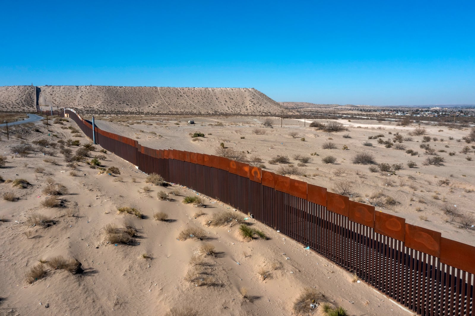 The border wall between Mexico, left, and the United States is pictured in Sunland Park, N.M., Tuesday, Jan. 21, 2025 in El Paso, Texas. (AP Photo/Andres Leighton)