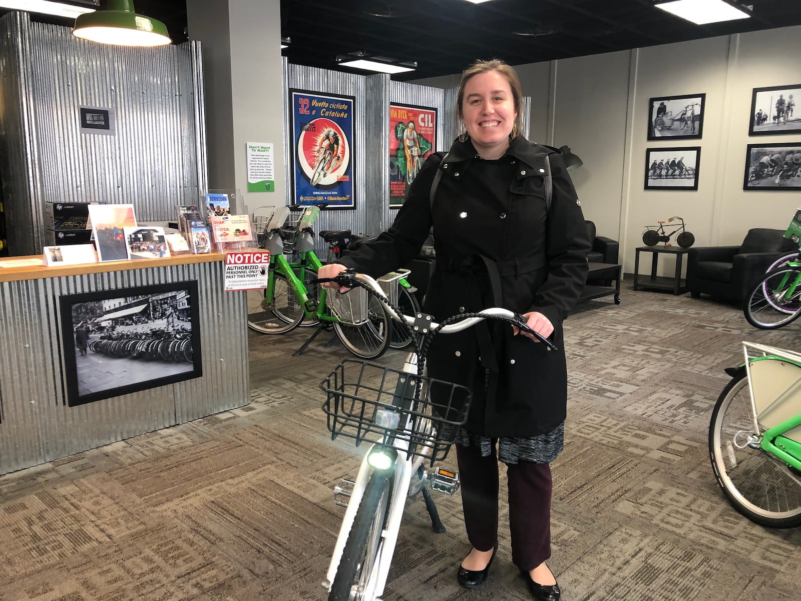 Laura Estandia, executive director of Bike Miami Valley, shows off Link Dayton Bike Share’s new electric bikes, called eLink. CORNELIUS FROLIK / STAFF