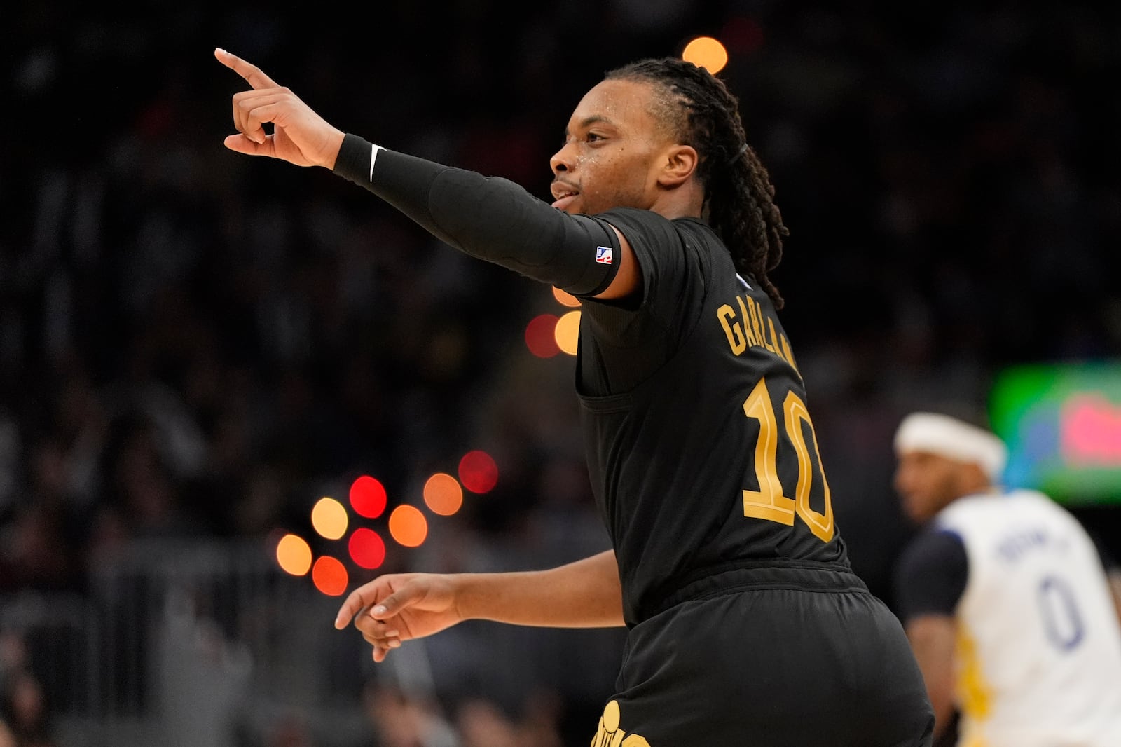 Cleveland Cavaliers guard Darius Garland (10) gestures after hitting a three-point basket in the second half of an NBA basketball game against the Golden State Warriors, Friday, Nov. 8, 2024, in Cleveland. (AP Photo/Sue Ogrocki)