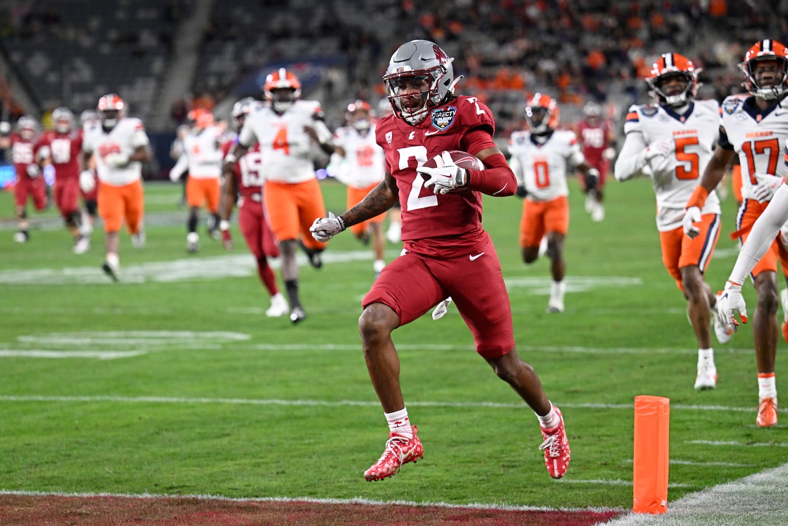 Washington State wide receiver Kyle Williams (2) breaks away from Syracuse defenders as he scores on a touchdown reception during the first half of the Holiday Bowl NCAA college football game Friday, Dec. 27, 2024, in San Diego. (AP Photo/Denis Poroy)