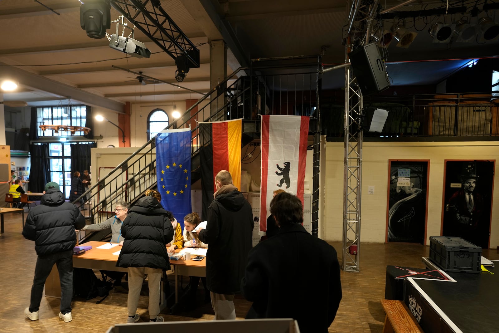 Residents arrive to cast a vote at a polling station in Berlin, Germany, Sunday, Feb. 23, 2025, during the German national election. (AP Photo/Markus Schreiber)