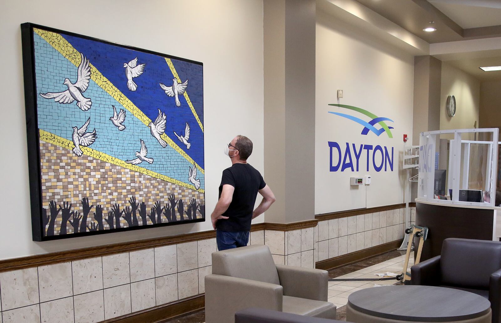 A mosaic mural, "9 Doves," was hung in the lobby of Dayton's City Hall Monday. The mural, designed by Jes McMillan, founder of the Mosaic Institute of Greater Dayton, was created with help from the community last year in response to the mass shooting in the Oregon District. LISA POWELL / STAFF