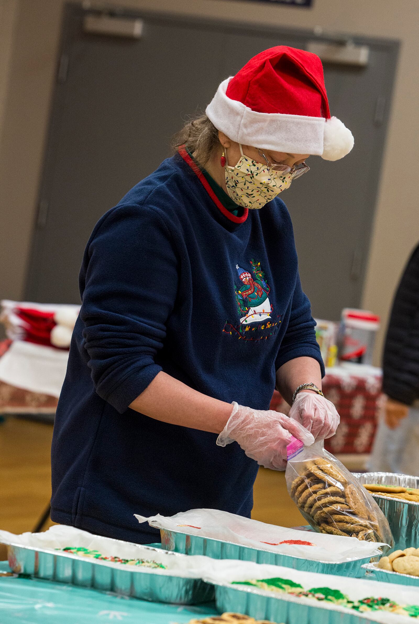 A volunteer prepares cookies to be packaged into individual bags Dec. 8 during the 2021 Airmen Cookie Drive at Wright-Patterson Air Force Base. U.S. AIR FORCE PHOTO/JAIMA FOGG