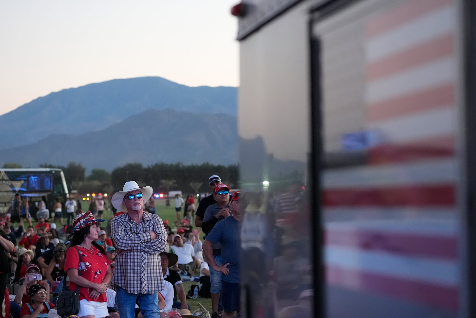 Attendees watch as Republican presidential nominee former President Donald Trump speaks at a campaign rally at the Calhoun Ranch, Saturday, Oct. 12, 2024, in Coachella, Calif. (AP Photo/Alex Brandon)