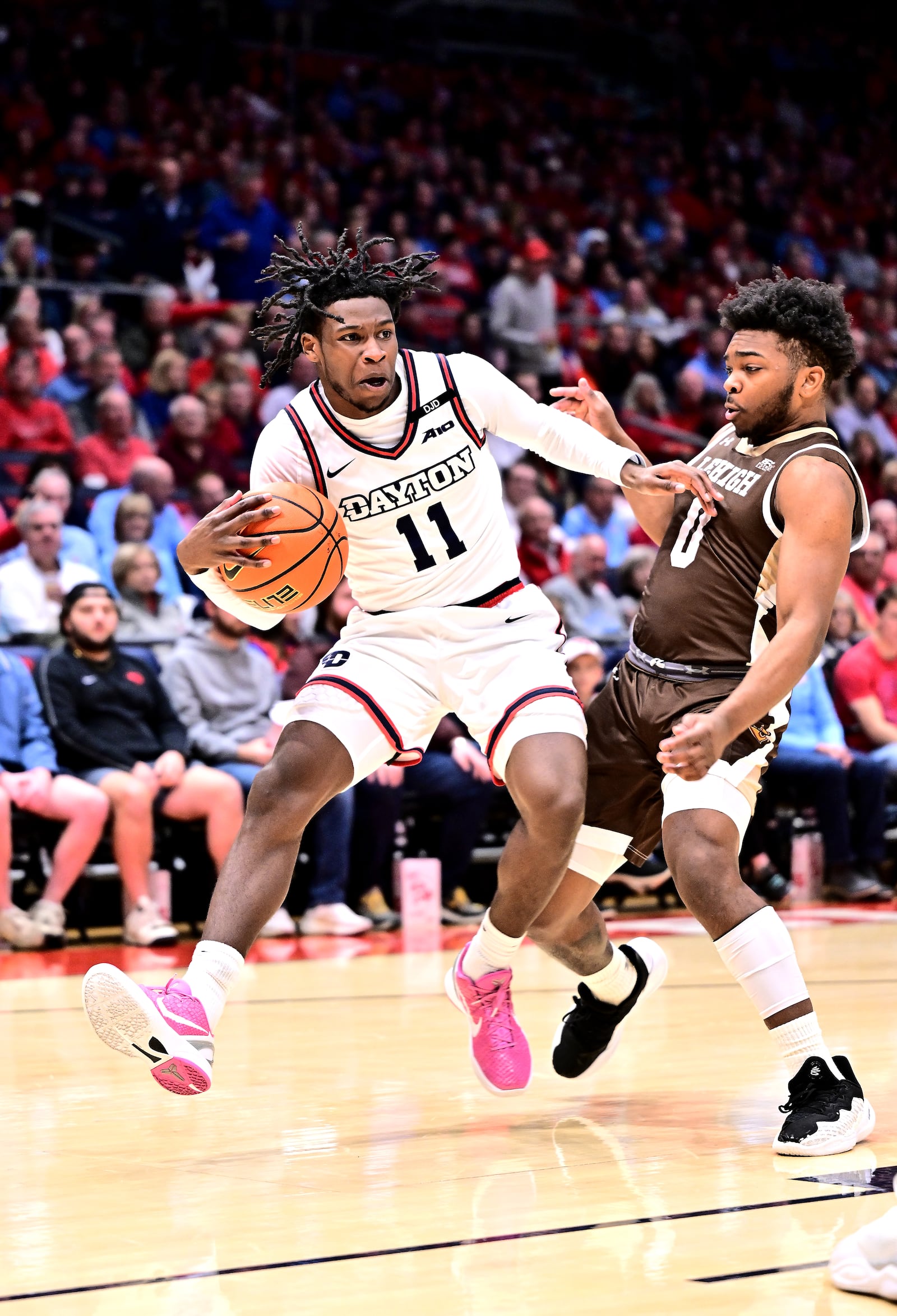 Dayton's Malachi Smith drives past Lehigh's Cam Gillus during Saturday's game at UD Arena. Erik Schelkun/UD Athletics photo