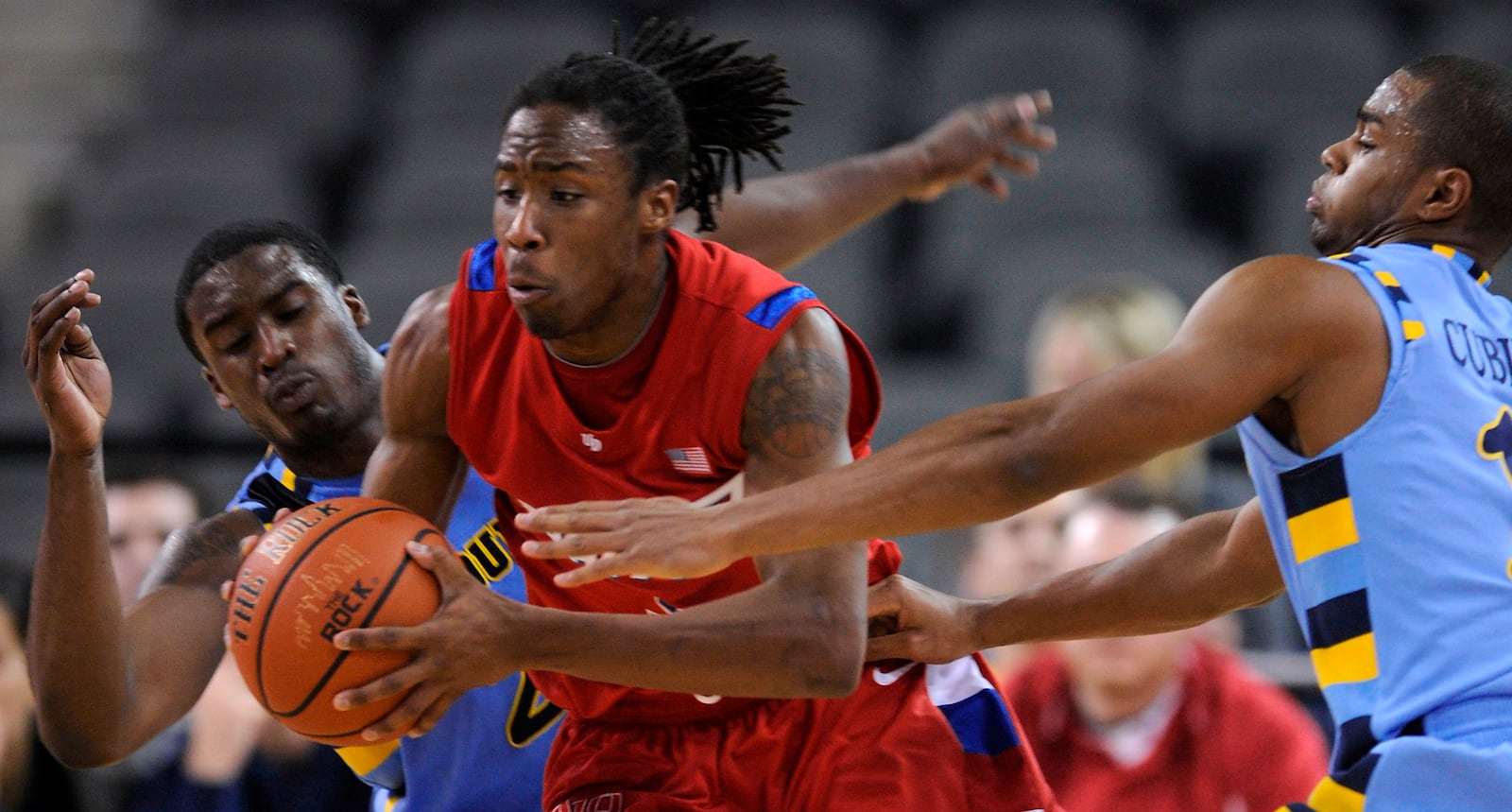 Dayton's Rob Lowery, center, looks to pass against Marquette's David Cubillan, right, and Wesley Matthews, left, in the second half of a game at the Sears Centre in Hoffman Estates, Ill., on Nov. 29, 2008. Dayton won the game 89-75. (AP Photo/Paul Beaty)