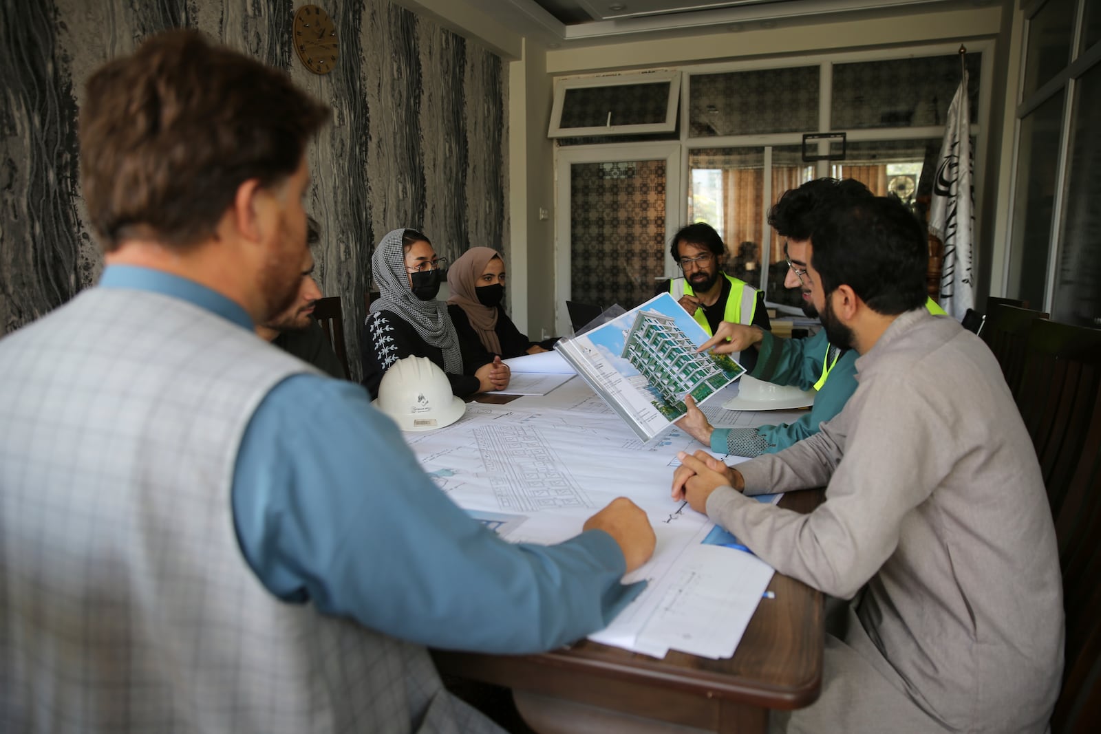 Engineers talk about the design of a luxury house at their office in the city of Kabul, Afghanistan, Sept. 23, 2024. (AP Photo/Siddiqullah Alizai)