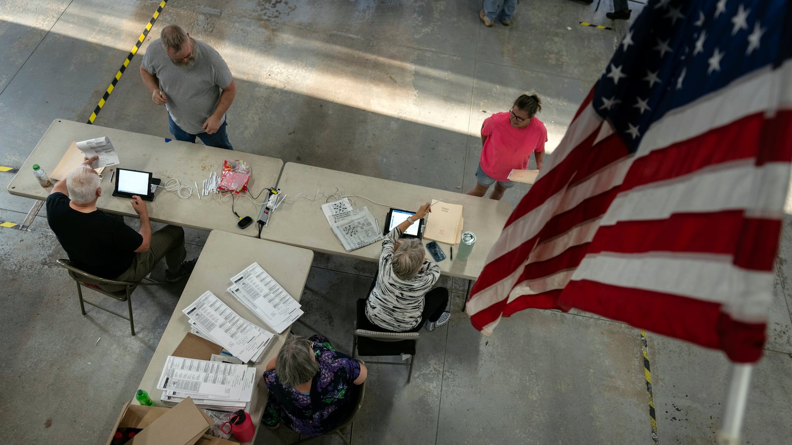 Voters check in as they arrive to vote at the Pleasant Township Fire Department on Election Day, Tuesday, Nov. 5, 2024, in Catawba, Ohio. (AP Photo/Carolyn Kaster)