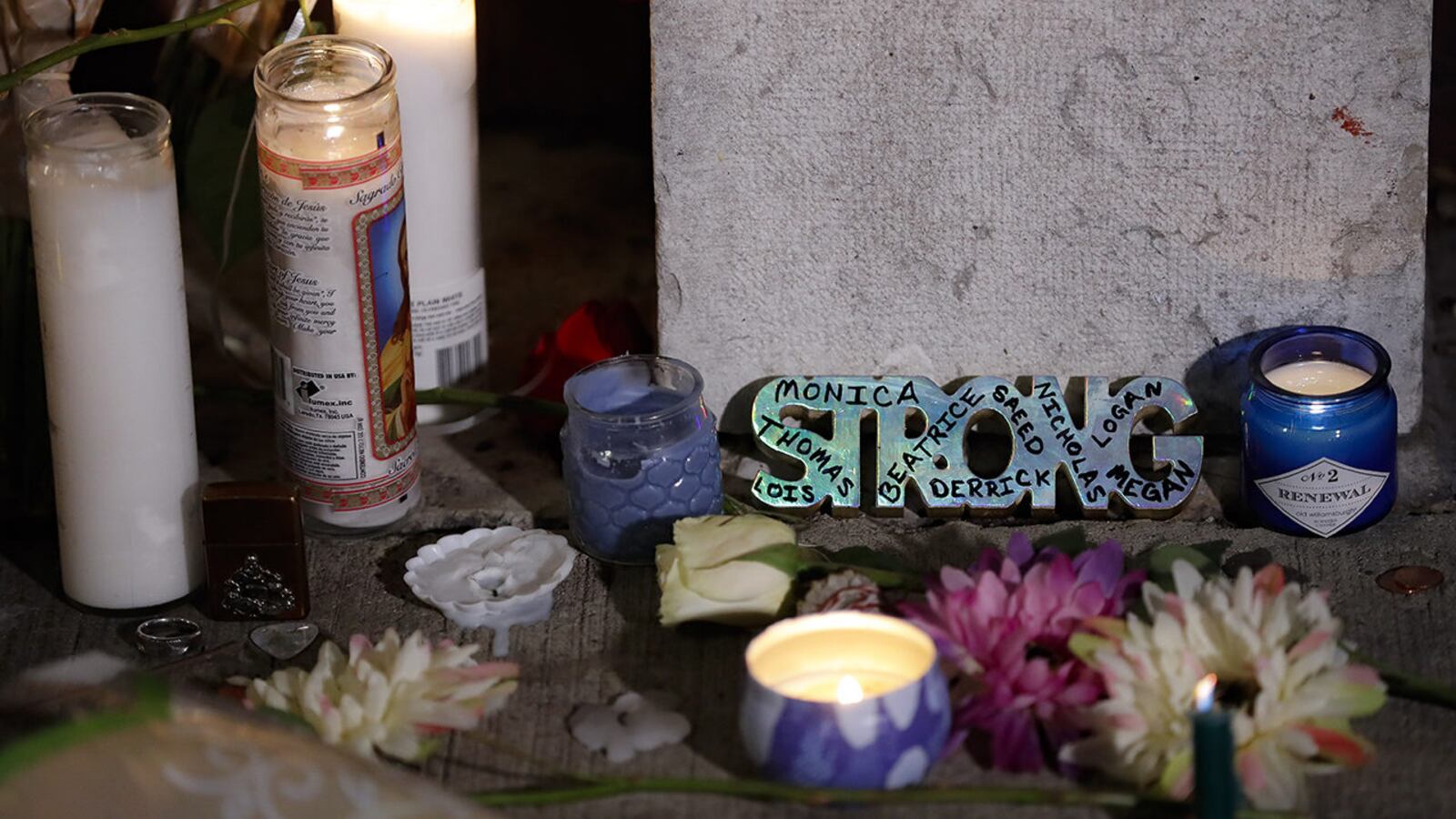 A makeshift memorial is setup outside Ned Peppers bar following a vigil at the scene of a mass shooting, Sunday, Aug. 4, 2019, in Dayton, Ohio.