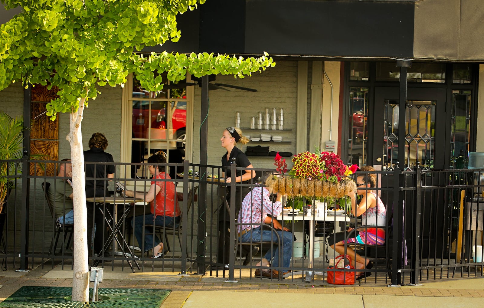 Outdoor dining at the Caroline restaurant in downtown Troy provides a view of the fountain and activity on the square. JIM WITMER / STAFF