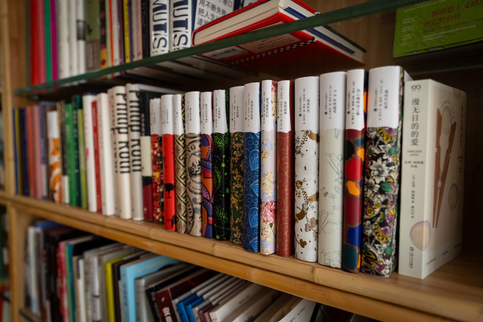 Books sit stacked on shelves in the JF Books bookstore in Washington, Thursday, Oct. 3, 2024. (AP Photo/Ben Curtis)