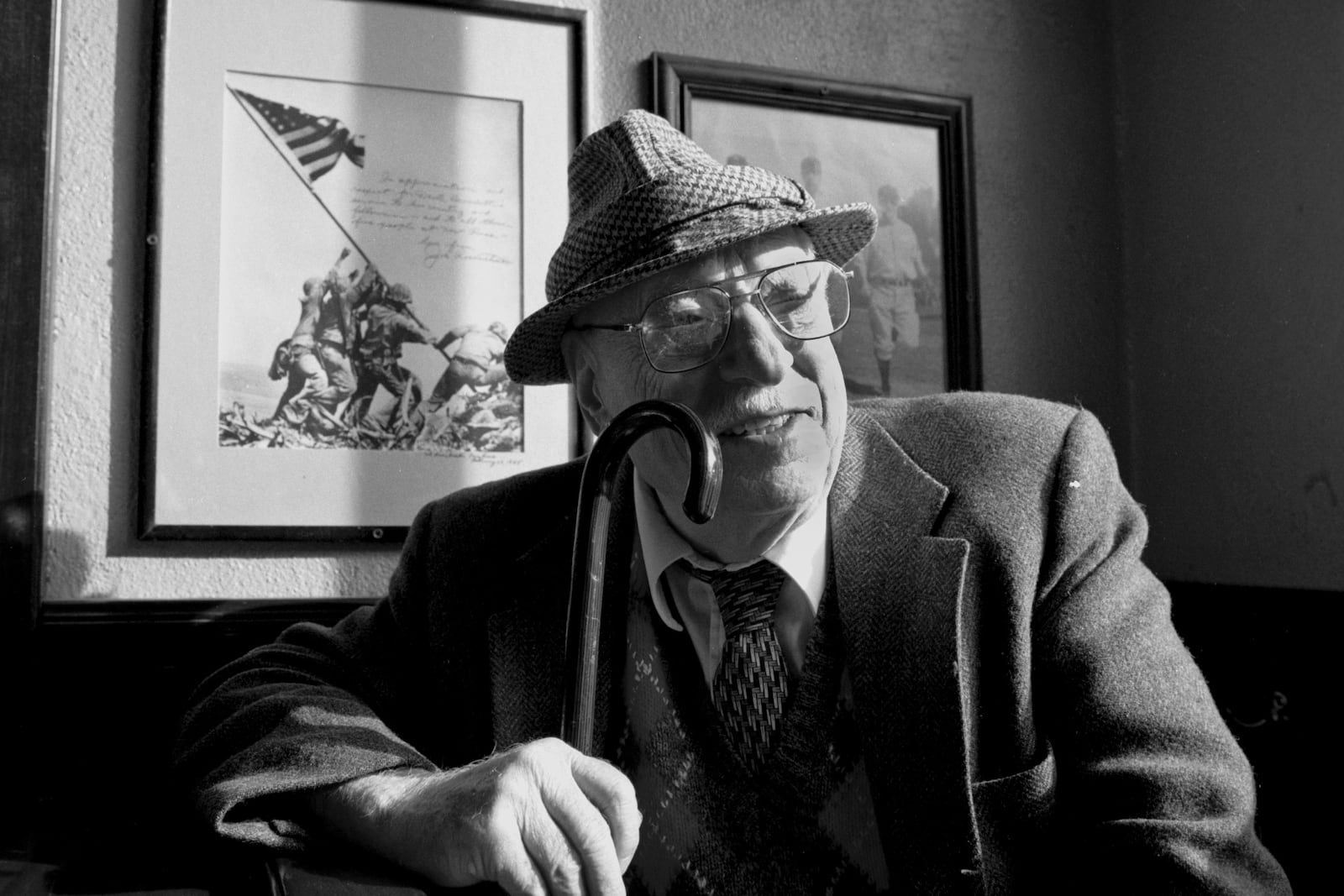 FILE- Joe Rosenthal, who took the iconic Iwo Jima flag raising photo in World War II, poses at the New Pisa Bar and restaurant in San Francisco, Dec. 20, 1994. (AP Photo/Eric Risberg, File)