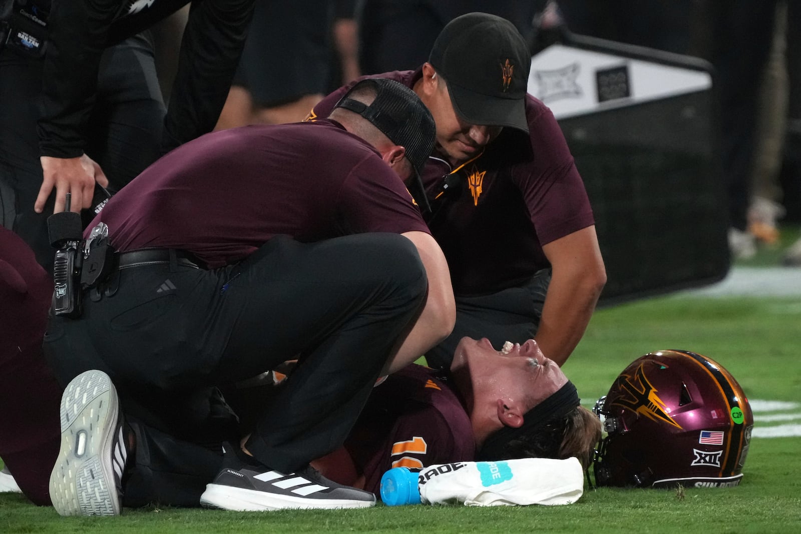 Arizona State quarterback Sam Leavitt (10) reacts after trainers talk to him after getting hit in the first half during an NCAA college football game against Utah, Friday, Oct. 11, 2024, in Tempe, Ariz. (AP Photo/Rick Scuteri)