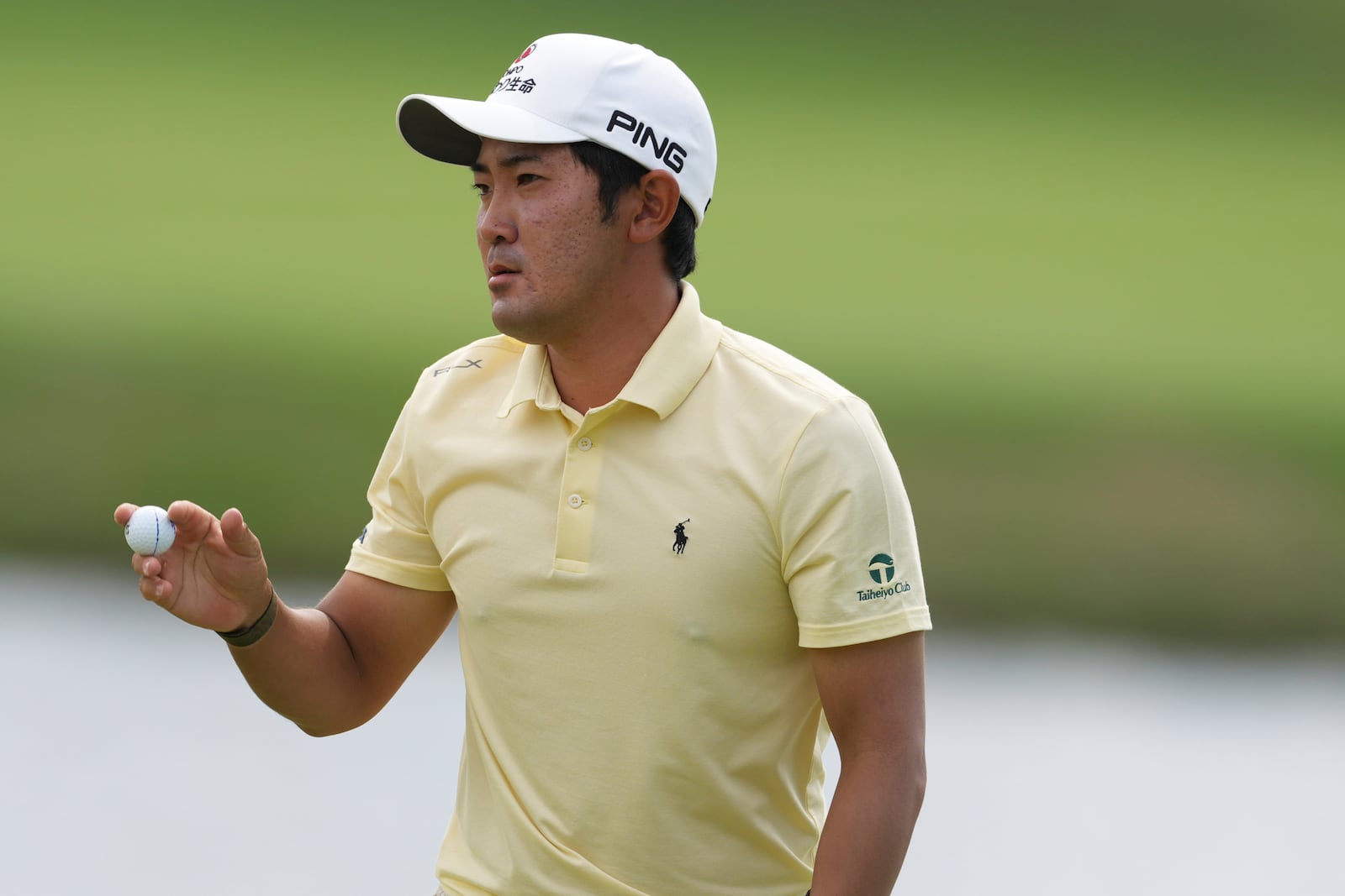 Takumi Kanaya, of Japan, holds the ball after making a birdie on the first hole during the first round of the Mexico Open golf tournament in Puerto Vallarta, Mexico, Thursday, Feb. 20, 2025. (AP Photo/Fernando Llano)