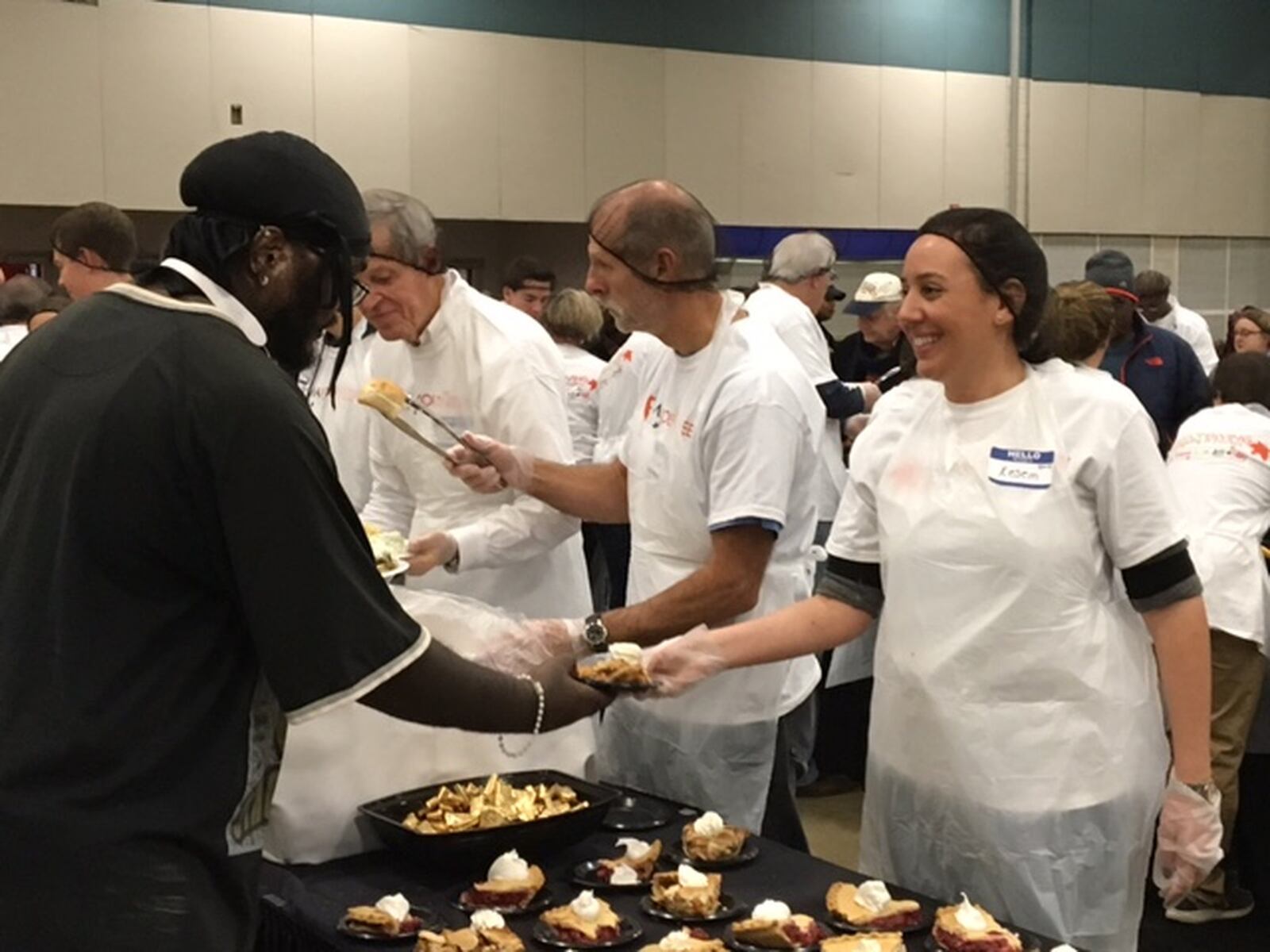 Kesem Simon, 30, visiting Dayton from Jerusalem, Israel, serves pie Thanksgiving Day on Thursday, Nov. 23, 2017, at the Feast of Giving event at the Dayton Convention Center. BARRIE BARBER/STAFF