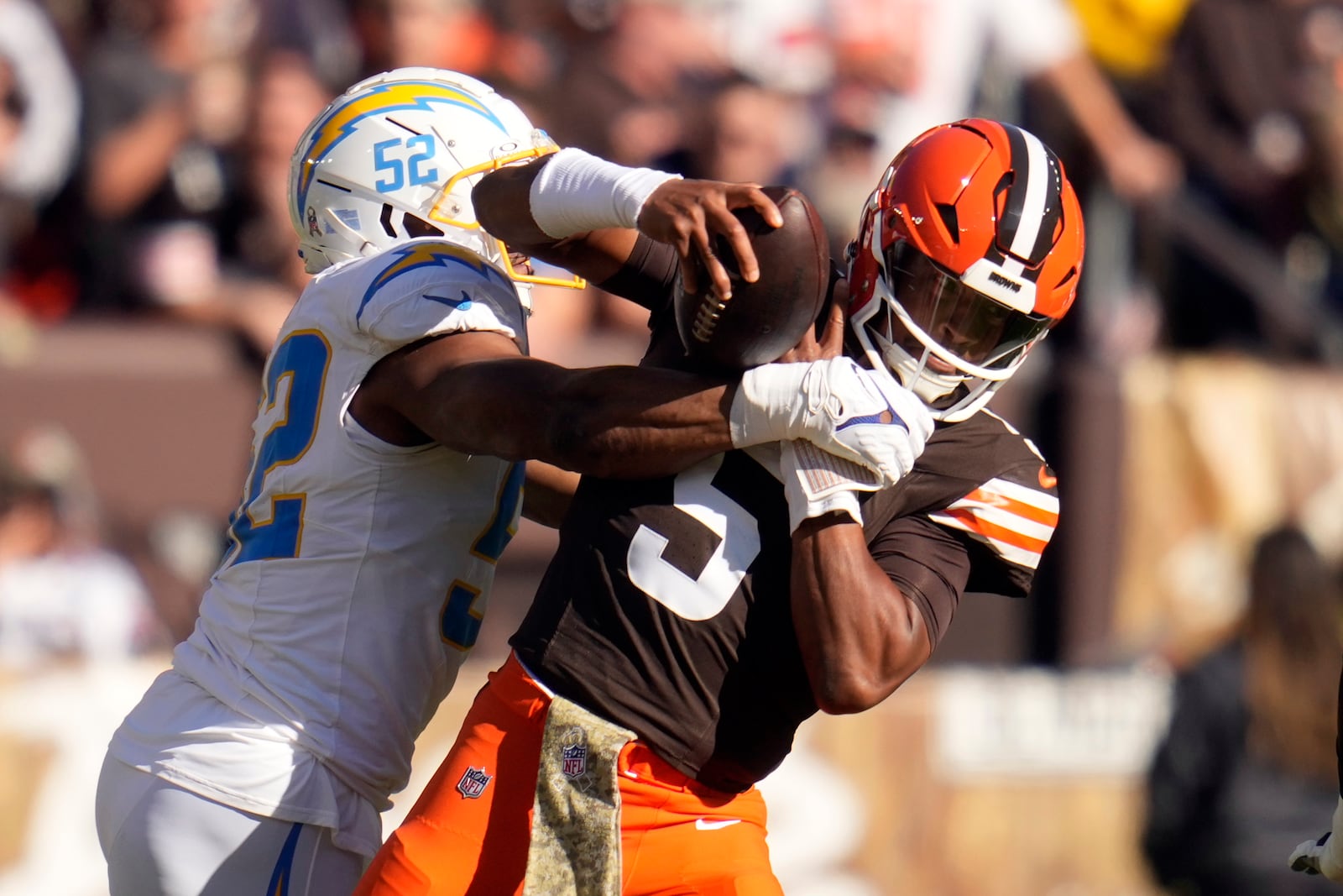 Los Angeles Chargers linebacker Khalil Mack (52) sacks Cleveland Browns quarterback Jameis Winston (5) for a 6-yard loss in the first half of an NFL football game Sunday, Nov. 3, 2024, in Cleveland. (AP Photo/Sue Ogrocki)