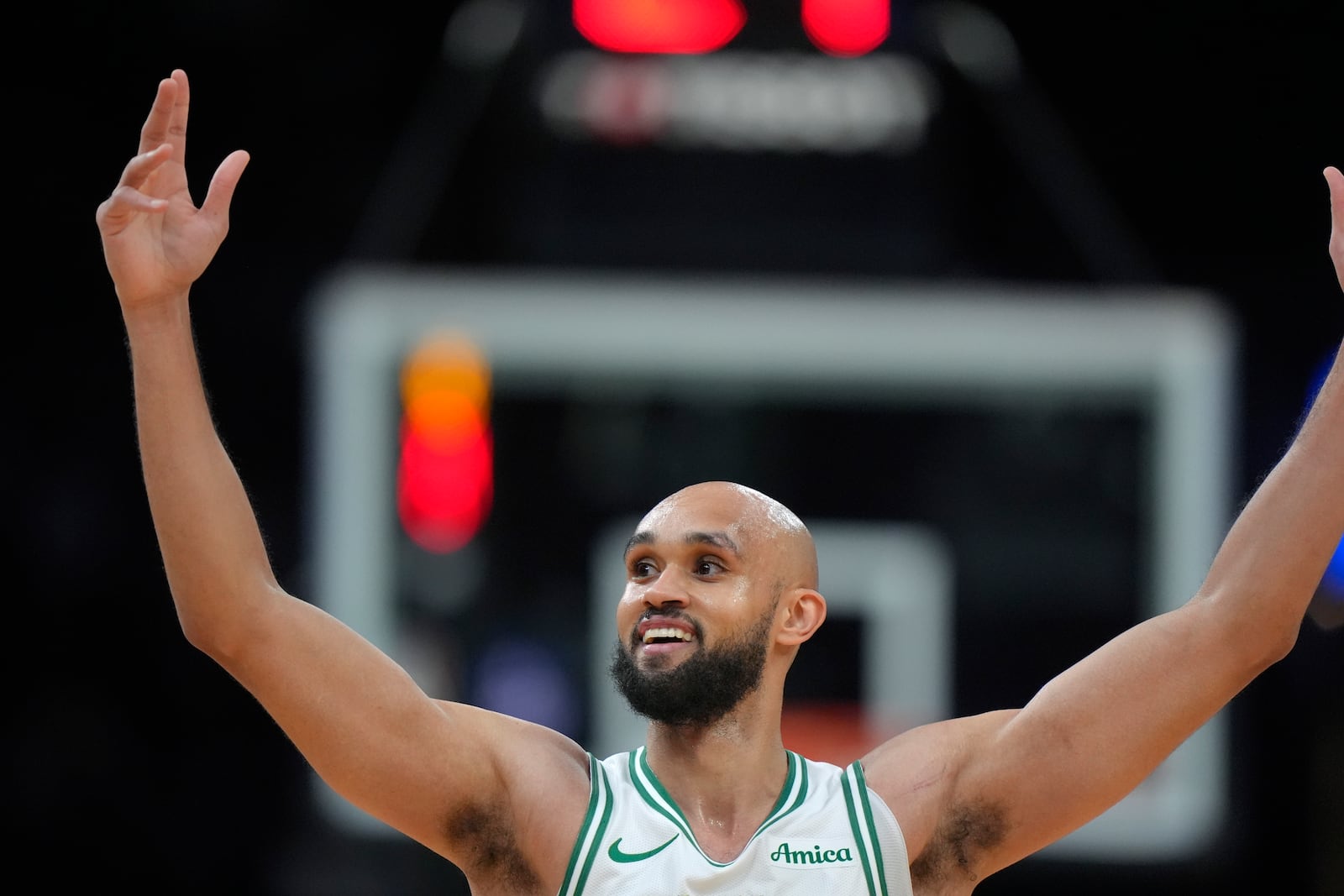 Boston Celtics guard Derrick White celebrates after his team scored a 3-point basket in the first half of an NBA basketball game against the Minnesota Timberwolves, Sunday, Nov. 24, 2024, in Boston. (AP Photo/Steven Senne)