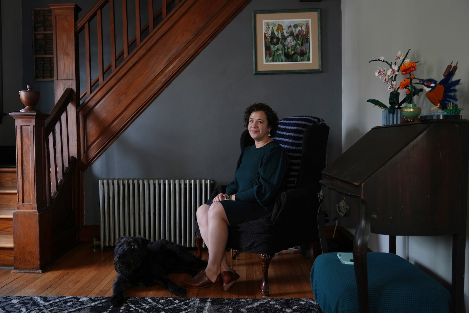 Hannah Jones, accompanied by her dog, Atlas, poses for a portrait at home near Philadelphia, Wednesday, March 12, 2025. (AP Photo/Matt Rourke)