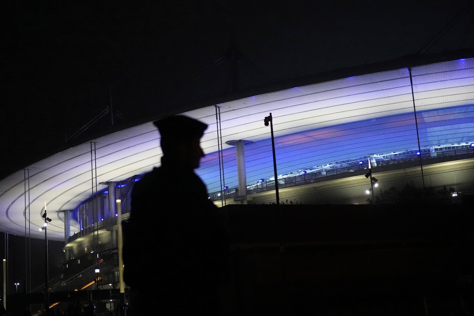 A police officer patrols by the Stade de France during the Nations League soccer match France against Israel outside the Stade de France stadium, Thursday, Nov. 14, 2024 in Saint-Denis, outside Paris. (AP Photo/Christophe Ena)