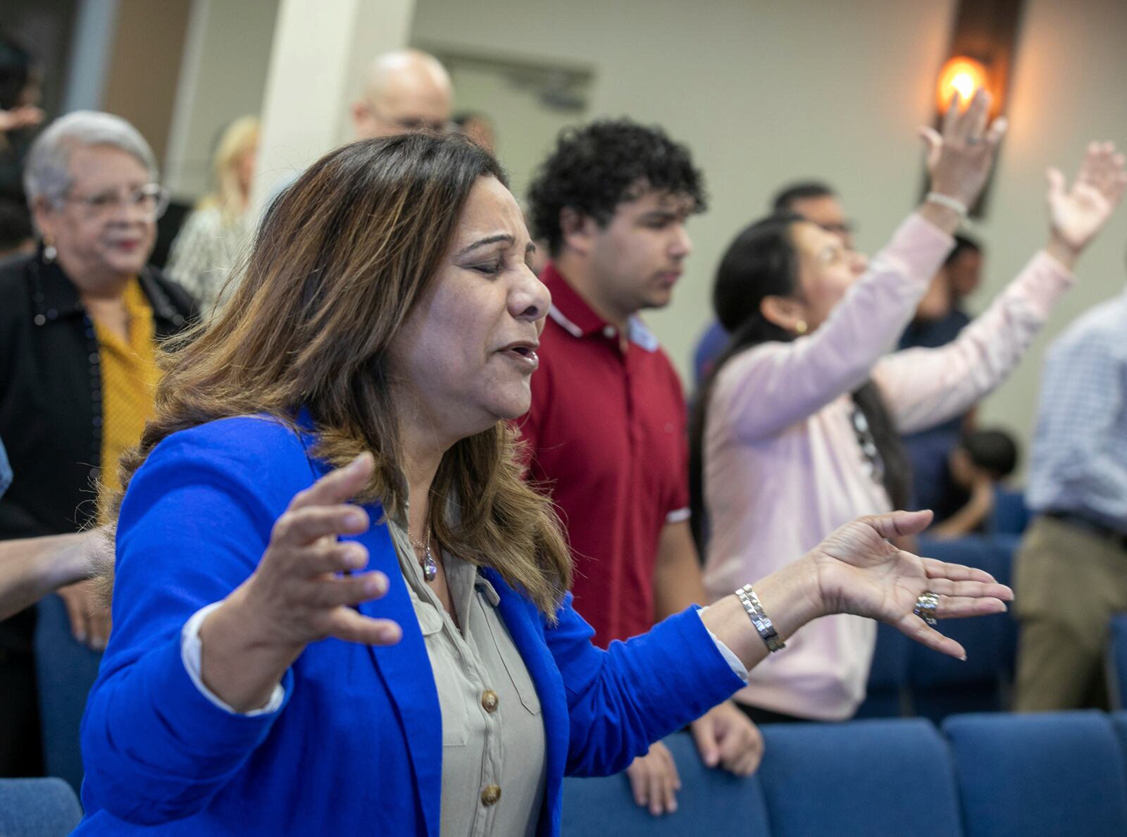 Fatima Guzman prays during a church service at the Centro Cristiano El Pan de Vida, a mid-size Church of God of Prophecy congregation in Kissimmee, Florida, Sunday, Feb. 2, 2025. (AP Photo/Alan Youngblood)