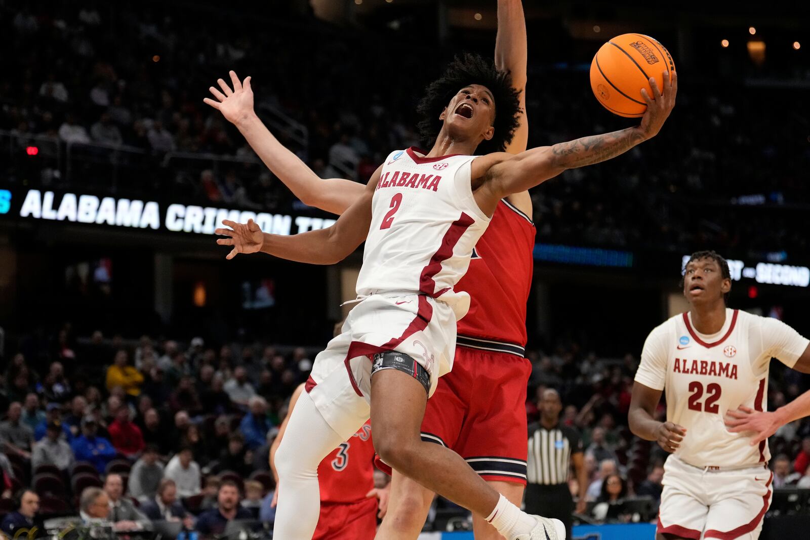 Alabama guard Aden Holloway (2) shoots in front of Saint Mary's center Harry Wessels, rear, in the first half in the second round of the NCAA college basketball tournament, Sunday, March 23, 2025, in Cleveland. (AP Photo/Sue Ogrocki)