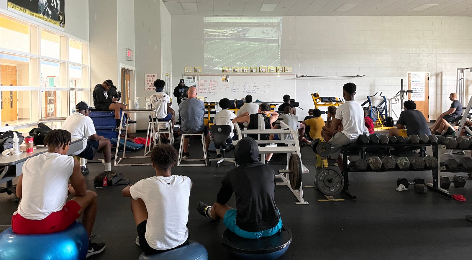 Springfield High School football players watch film after working out during the summer.