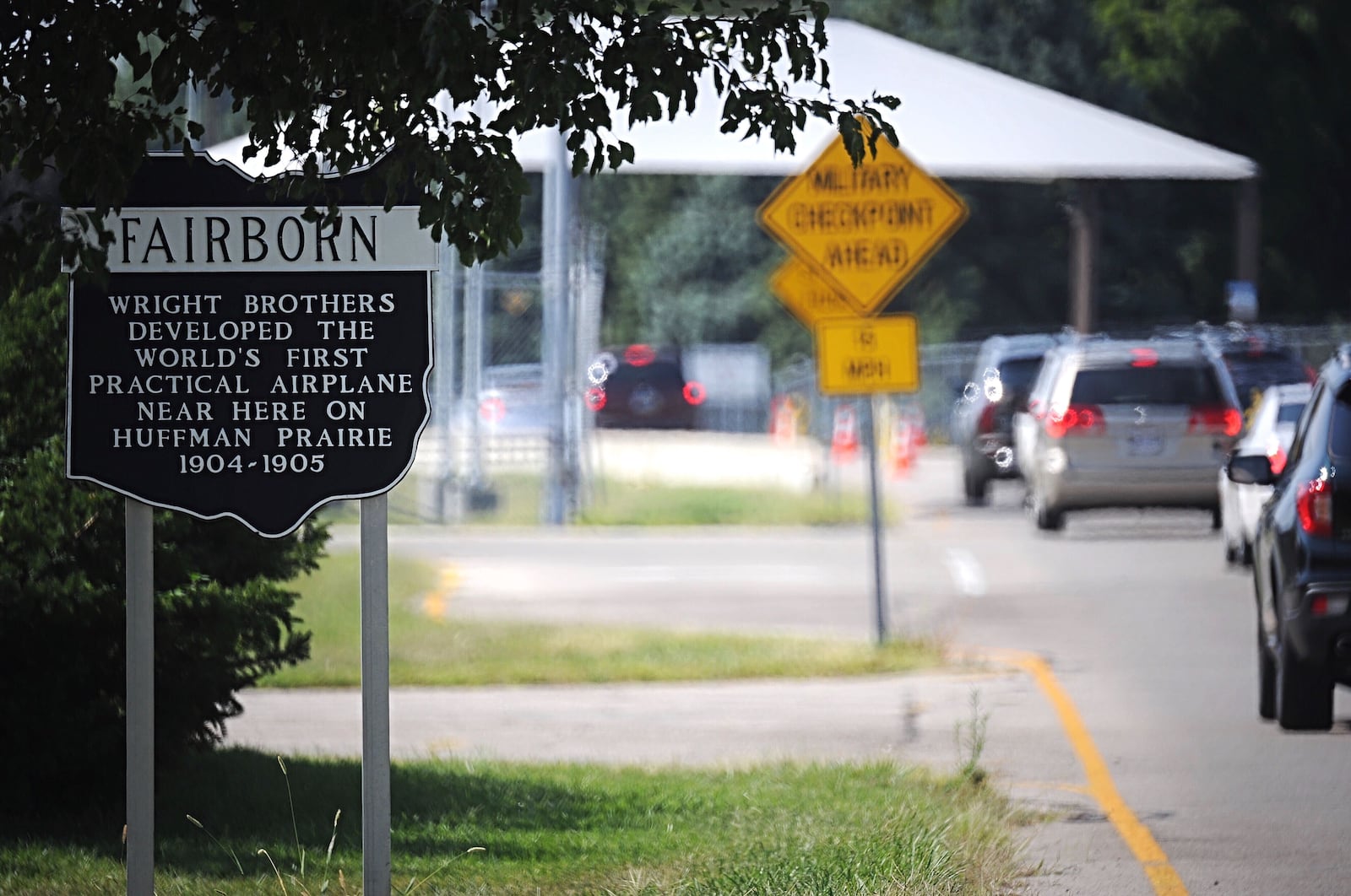 A historic marker in Fairborn denotes the efforts of the Wright Brothers in a photo take near a gate to Wright-Patterson Air Force Base.  MARSHALL GORBY/STAFF