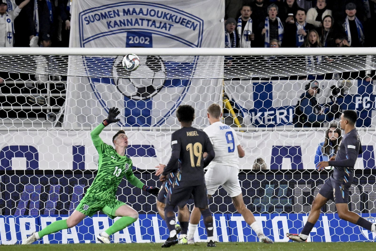 Fredrik Jensen of Finland, centre right, fails to score past goalkeeper Dean Henderson of England during the UEFA Nations League soccer match between Finland and England, at the Olympic Stadium in Helsinki, Finland, Sunday, Oct. 13, 2024. (Antti Aimo-Koivisto/Lehtikuva via AP)