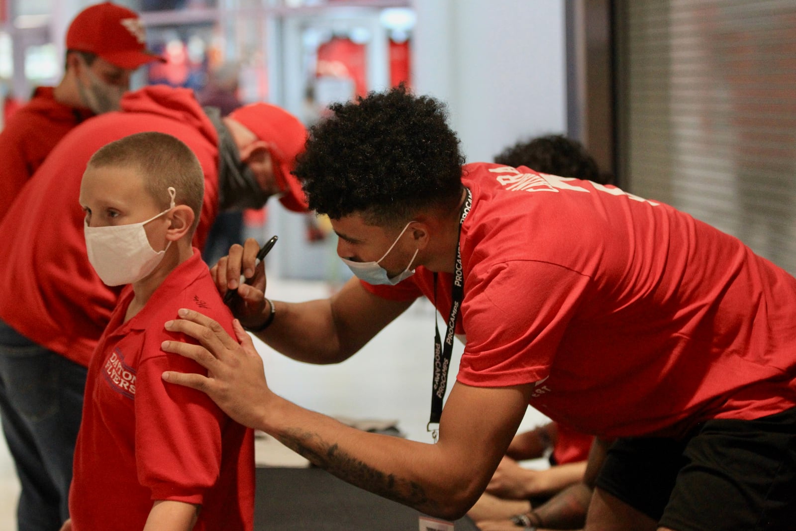 Toumani Camara signs an autograph at the Henny Penny Red Blue Dayton Basketball Fan Fest on Saturday, Oct. 16, 2021, at UD Arena. David Jablonski/Staff