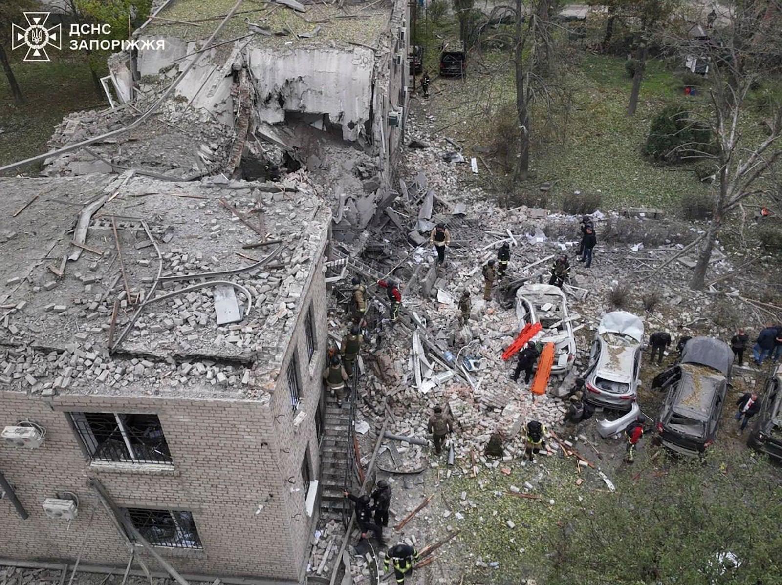 In this photo provided by the Ukrainian Emergency Service, emergency workers clear the rubble after an overnight Russian attack with guided bombs in Zaporizhzhia, Ukraine, Monday, Oct. 21, 2024. (Ukrainian Emergency Service via AP)