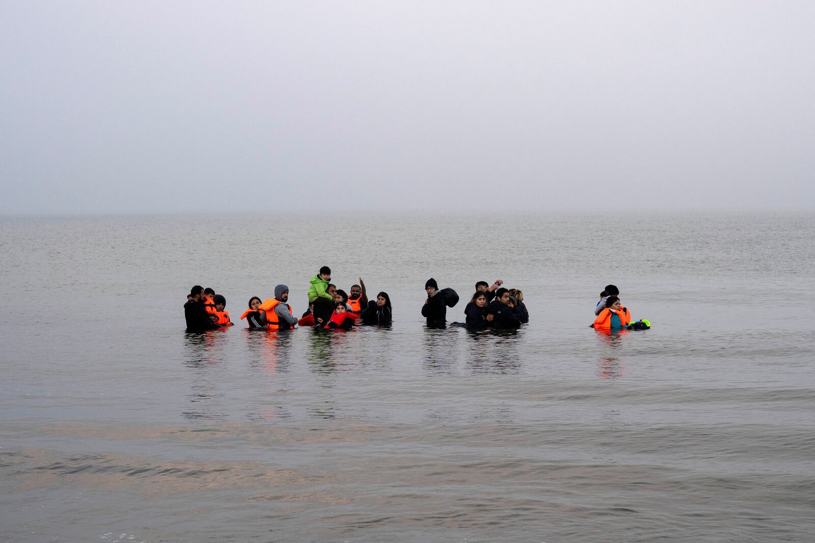 FILE - A group of Kurdish migrants from Iran and Iraq who failed in their attempt to reach the United Kingdom by boat after being discovered by the police refuse to return to shore on the beach of Ambleteuse, northern France, on May 19, 2024. (AP Photo/Bernat Armangue, File)